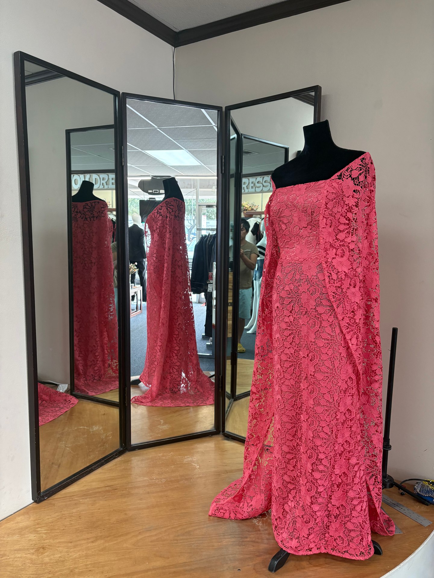 Front view of the custom floral lace evening gown with open lace panels and mirror reflections at LT Tailors